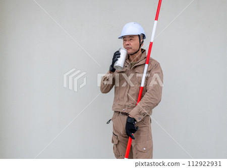 On-site workers hydrate themselves between tasks. On-site workers hydrate themselves between tasks. 112922931