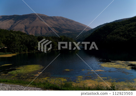 Lake Turin on border of Macedonia and Albania Clear water sunrise or sunset blue sky. High quality  112923503