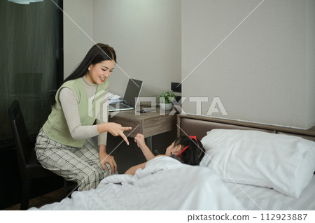 Mother and her cute little daughter having fun in bedroom. Family concept Mother and her cute little daughter having fun in bedroom. Family concept 112923887