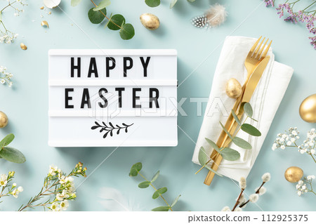 lightbox text Happy Easter, table setting, easter eggs and spring branches 112925375