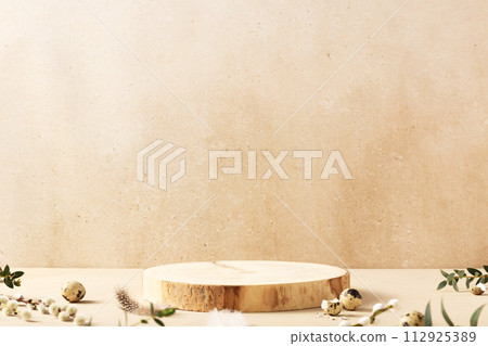 Empty round wooden podiums, quail eggs with green eucalyptus branches on a beige background Empty round wooden podiums, quail eggs with green eucalyptus branches on a beige background 112925389