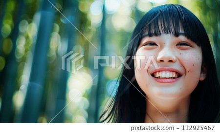 Young woman smiling in bamboo forest Young woman smiling in bamboo forest 112925467