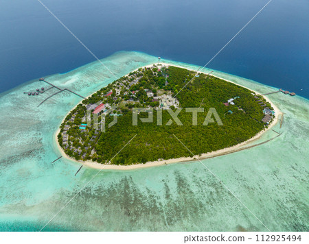 Island with beach and coral reef in the tropics view from above. Pom Pom islet. Tun Sakaran Marine Park. Borneo, Sabah, Malaysia. Island with beach and coral reef in the tropics view from above. Pom Pom islet. Tun Sakaran Marine Park. Borneo, Sabah, Malaysia. 112925494