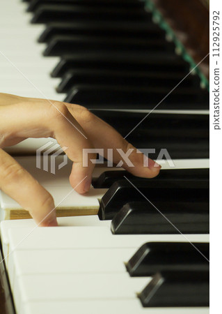 Teenager hand on piano keys, Concept music practice, training, developing fluent hand movement Teenager hand on piano keys, Concept music practice, training, developing fluent hand movement 112925792