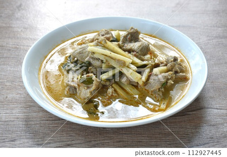 spicy boiled slice fresh coconut shoot with pork in coconut milk green curry soup on plate  112927445