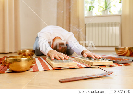 morning yoga practice with sadhu nails. mans foot on the wooden desk with sharp metal nails morning yoga practice with sadhu nails. mans foot on the wooden desk with sharp metal nails 112927508