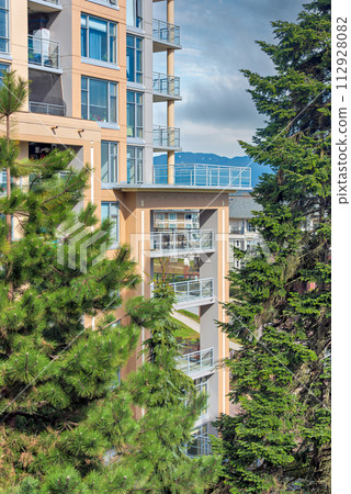 High-rise residential building with big patio on bright sunny day 112928082