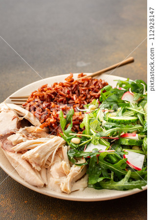 Chicken breast with red rice and salad mix with seasonal organic vegetables Chicken breast with red rice and salad mix with seasonal organic vegetables 112928147