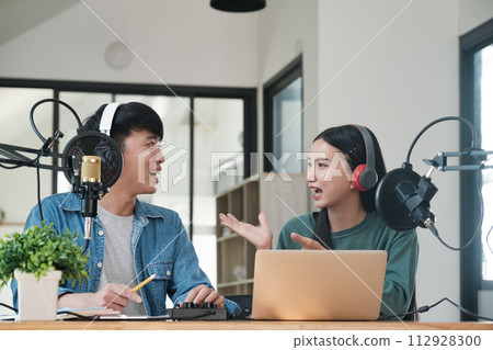 Two people are talking on a microphone Two people are talking on a microphone 112928300