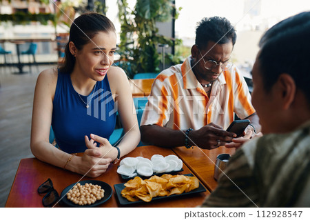 Group of friends meeting in cafe to discuss news and hang out Group of friends meeting in cafe to discuss news and hang out 112928547