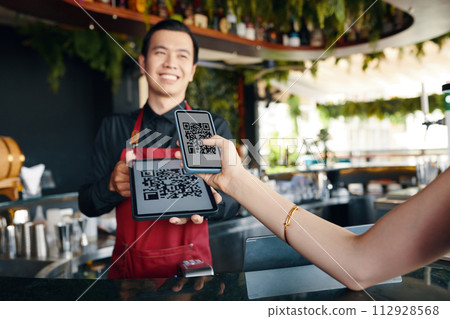 Restaurant guest scanning qr code when paying for order Restaurant guest scanning qr code when paying for order 112928568