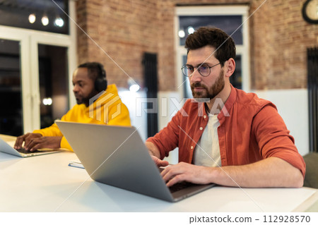 Two colleagues working together and looking serious 112928570