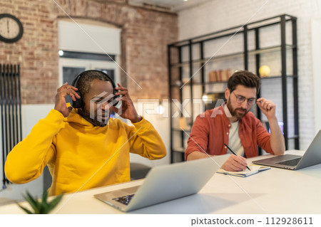 Two men working together in a home office 112928611