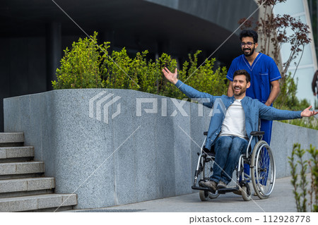 Young man in a wheelchair looking happy and exited Young man in a wheelchair looking happy and exited 112928778