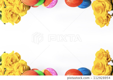 Colorful easter eggs and yellow roses on white background with copy space for text 112928954