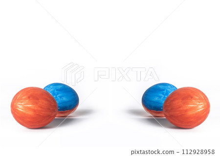 Red and blue painted easter eggs isolated on white background with copy space. Red and blue painted easter eggs isolated on white background with copy space. 112928958