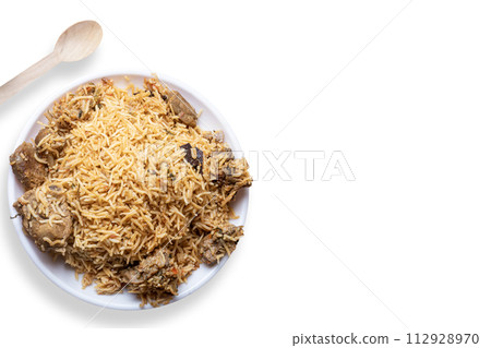 Mutton biryani is a popular Indian dish. Top view of delicious mutton biryani served on white plate on white background. 112928970