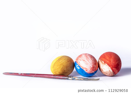 Colorful painted Easter eggs and paint brush on white background with copy space Colorful painted Easter eggs and paint brush on white background with copy space 112929058
