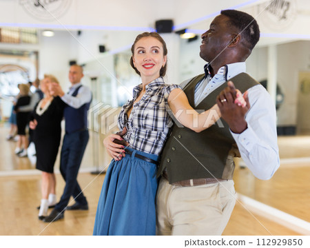 Man and woman performing ballroom dance in dancing room Man and woman performing ballroom dance in dancing room 112929850