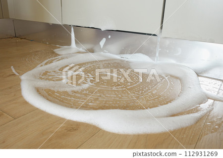 Spilled Water from a Dish Washer On Kitchen Floor Spilled Water from a Dish Washer On Kitchen Floor 112931269