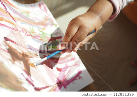 child girl drawing on paper sitting on floor child girl drawing on paper sitting on floor 112931389