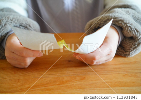 An elementary school child is folding origami. 4th grade elementary school student, 10 years old. An elementary school child is folding origami. 4th grade elementary school student, 10 years old. 112931845