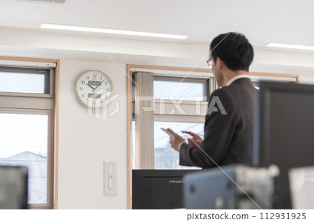 A male businessman in a suit who is concerned about time 112931925