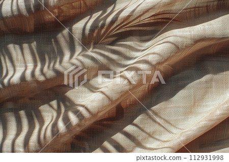Beige textile surface with folds and shadows of palm leaves. Minimalistic, natural background. Nordic style backdrop. Generative AI. 112931998