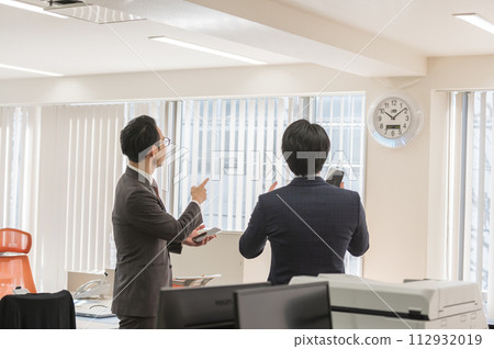 A male businessman in a suit who is concerned about time A male businessman in a suit who is concerned about time 112932019