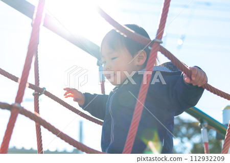 A boy playing in a park in winter A boy playing in a park in winter 112932209