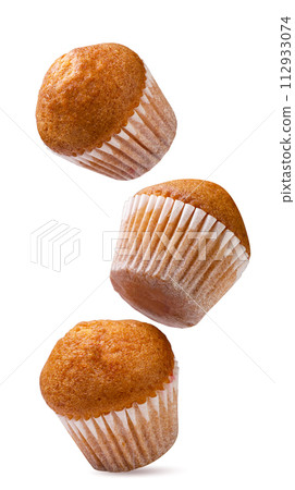 Cupcakes falling on a white background. Isolated 112933074