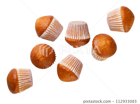 Set of cupcakes falling on a white background. Isolated Set of cupcakes falling on a white background. Isolated 112933083
