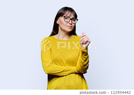 Portrait of smiling mature confident woman on white studio background Portrait of smiling mature confident woman on white studio background 112934442