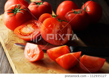 tomatoes cut on a cutting board 112935127