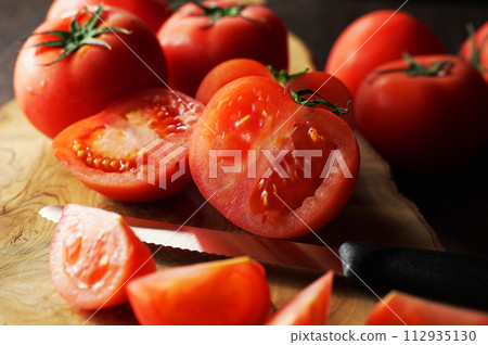tomatoes cut on a cutting board tomatoes cut on a cutting board 112935130