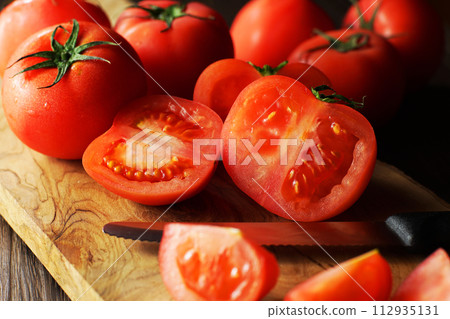 tomatoes cut on a cutting board tomatoes cut on a cutting board 112935131