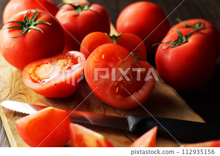 tomatoes cut on a cutting board 112935156