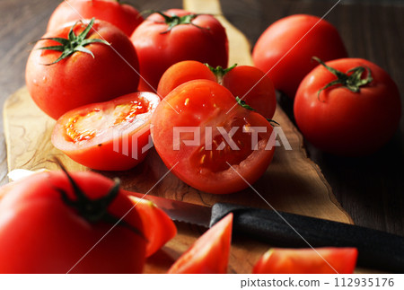 tomatoes cut on a cutting board 112935176