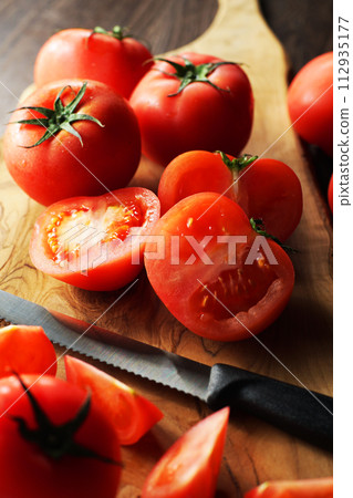 tomatoes cut on a cutting board tomatoes cut on a cutting board 112935177