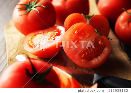 tomatoes cut on a cutting board 112935180