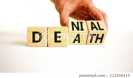 Denial death symbol. Concept words Denial Death on wooden block. Beautiful white table white background. Businessman hand. Business denial death concept. Copy space. 112936415