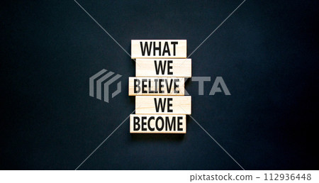 We become or believe symbol. Concept word What we believe We become on wooden block. Beautiful black table black background. Business we become or believe concept. Copy space. 112936448