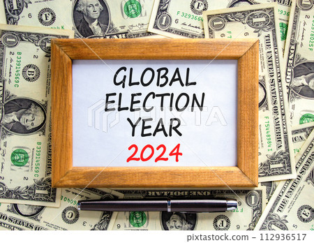 Global election year 2024 symbol. Concept words Global election year 2024 on beautiful frame. Beautiful dollar bills background. Dollar bills. Business Global election year 2024 concept. Copy space 112936517