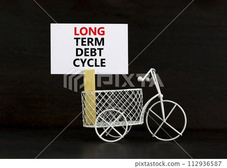 Long term debt cycle symbol. Concept words Long term debt cycle on beautiful white paper on clothespin. Bicycle model. Beautiful black background. Business Long term debt cycle concept. Copy space. Long term debt cycle symbol. Concept words Long term debt cycle on beautiful white paper on clothespin. Bicycle model. Beautiful black background. Business Long term debt cycle concept. Copy space. 112936587