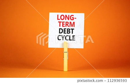 Long-term debt cycle symbol. Concept words Long-term debt cycle on beautiful white paper on clothespin. Beautiful orange background. Business Long-term debt cycle concept. Copy space. Long-term debt cycle symbol. Concept words Long-term debt cycle on beautiful white paper on clothespin. Beautiful orange background. Business Long-term debt cycle concept. Copy space. 112936593