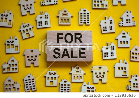 Wooden blocks form the words 'for sale', miniature wooden houses. Beautiful yellow background, copy space. Business concept. Wooden blocks form the words 'for sale', miniature wooden houses. Beautiful yellow background, copy space. Business concept. 112936636