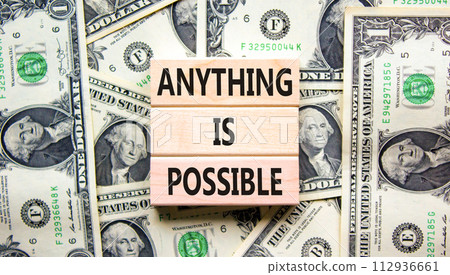 Anything is possible symbol. Concept words Anything is possible on beautiful wooden blocks. Dollar bills. Beautiful dollar bills background. Business anything possible concept. Copy space. Anything is possible symbol. Concept words Anything is possible on beautiful wooden blocks. Dollar bills. Beautiful dollar bills background. Business anything possible concept. Copy space. 112936661