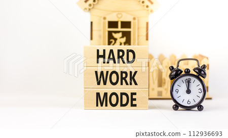 Hard work mode symbol. Concept words Hard work mode on wooden block on a beautiful white table white background. Black alarm clock. Business and Hard work mode concept. Copy space. 112936693