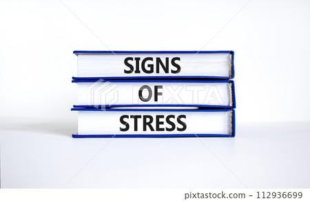 Signs of stress symbol. Concept words Signs of stress on books. Beautiful white table white background. Psychological business and signs of stress concept. Copy space. 112936699