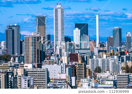 Tokyo cityscape in Japan Ikebukuro subcenter. View of Sunshine 60 and tower apartments = March 10th Tokyo cityscape in Japan Ikebukuro subcenter. View of Sunshine 60 and tower apartments = March 10th 112936999